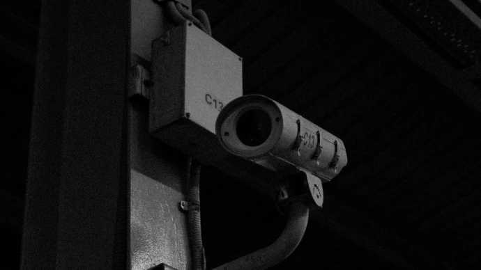 a black and white photo of a security camera